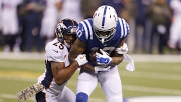 Nov 8, 2015; Indianapolis, IN, USA; Denver Broncos cornerback Chris Harris Jr. (25) tackles Indianapolis Colts wide receiver Donte Moncrief (10) at Lucas Oil Stadium. Indianapolis defeats Denver 27-24. Mandatory Credit: Brian Spurlock-USA TODAY Sports
