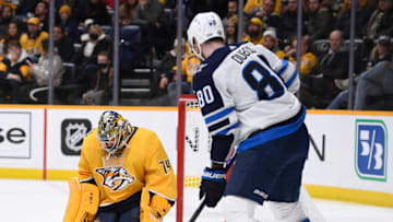 Jan 20, 2022; Nashville, Tennessee, USA; Nashville Predators goaltender Juuse Saros (74) blocks the shot of Winnipeg Jets left wing Pierre-Luc Dubois (80) during the second period at Bridgestone Arena. Mandatory Credit: Steve Roberts-USA TODAY Sports