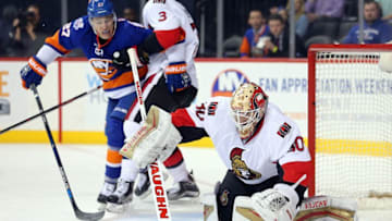 Mar 23, 2016; Brooklyn, NY, USA; Ottawa Senators goalie Andrew Hammond (30) makes a save in front of New York Islanders center Anders Lee (27) during the second period at Barclays Center. Mandatory Credit: Brad Penner-USA TODAY Sports