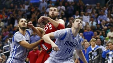 Nov 6, 2015; Orlando, FL, USA; Toronto Raptors center Jonas Valanciunas (17) battles for the rebound with Orlando Magic forward Evan Fournier (10) and forward Jason Smith (14) during the fourth quarter of a basketball game at Amway Center. The Magic won 92-87. Mandatory Credit: Reinhold Matay-USA TODAY Sports