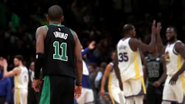 BOSTON - JANUARY 26: The Golden State Warriors celebrate their 115-111 win over the Boston Celtics as Boston Celtics guard Kyrie Irving (11) looks on. The Boston Celtics host the Golden State Warriors in a regular season NBA basketball game at TD Garden in Boston on Jan. 26, 2019. (Photo by Barry Chin/The Boston Globe via Getty Images)