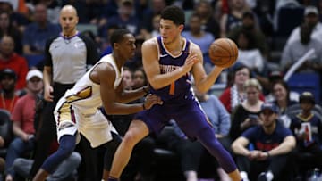 NEW ORLEANS, LA - FEBRUARY 26: Devin Booker #1 of the Phoenix Suns drives against Rajon Rondo #9 of the New Orleans Pelicans during the second half at the Smoothie King Center on February 26, 2018 in New Orleans, Louisiana. NOTE TO USER: User expressly acknowledges and agrees that, by downloading and or using this Photograph, user is consenting to the terms and conditions of the Getty Images License Agreement. (Photo by Jonathan Bachman/Getty Images)