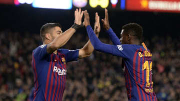 Barcelona's French forward Ousmane Dembele (R) celebrates scoring the opening goal with Barcelona's Uruguayan forward Luis Suarez during the Spanish League football match between FC Barcelona and RC Celta de Vigo at the Camp Nou stadium in Barcelona on Decemeber 22, 2018. (Photo by Josep LAGO / AFP) (Photo credit should read JOSEP LAGO/AFP/Getty Images)