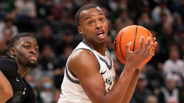 Dec 21, 2021; Detroit, Michigan, USA; Oakland Golden Grizzlies forward Micah Parrish (3) turns with the ball in front of Michigan State Spartans forward Gabe Brown (44) during the first half at Little Caesars Arena. Mandatory Credit: Raj Mehta-USA TODAY Sports