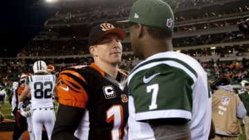 Oct 27, 2013; Cincinnati, OH, USA; Cincinnati Bengals quarterback Andy Dalton (14) stops to talk to New York Jets quarterback Geno Smith (7) after the game at Paul Brown Stadium. Mandatory Credit: Marc Lebryk-USA TODAY Sports