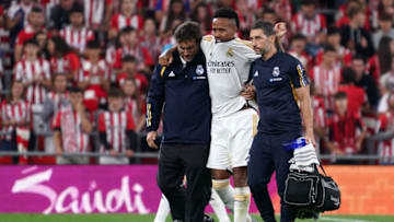 Real Madrid's Brazilian defender #03 Eder Militao is helped to leave the pitch after resulting injured during the Spanish Liga football match between Athletic Bilbao and Real Madrid at the San Mames stadium in Bilbao on August 12, 2023. (Photo by CESAR MANSO / AFP) (Photo by CESAR MANSO/AFP via Getty Images)