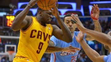 Mar 16, 2014; Los Angeles, CA, USA; Cleveland Cavaliers forward Luol Deng (9) drives to the basket past Los Angeles Clippers forward Matt Barnes (22) during second quarter action at Staples Center. Mandatory Credit: Robert Hanashiro-USA TODAY Sports