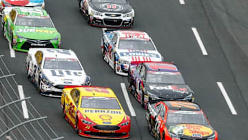 May 29, 2016; Concord, NC, USA; Pole winner Sprint Cup Series driver Martin Truex Jr. (78) and driver Joey Logano (22) lead the pack to start the Coca-Cola 600 at Charlotte Motor Speedway. Mandatory Credit: Jim Dedmon-USA TODAY Sports