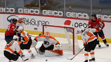 Apr 13, 2021; Washington, District of Columbia, USA; Philadelphia Flyers goaltender Brian Elliott (37) makes a save on Washington Capitals right wing Anthony Mantha (39) in the second period at Capital One Arena. Mandatory Credit: Geoff Burke-USA TODAY Sports