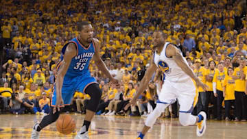 May 30, 2016; Oakland, CA, USA; Oklahoma City Thunder forward Kevin Durant (35) dribbles the basketball against Golden State Warriors forward Andre Iguodala (9) during the fourth quarter in game seven of the Western conference finals of the NBA Playoffs at Oracle Arena. The Warriors defeated the Thunder 96-88. Mandatory Credit: Kyle Terada-USA TODAY Sports