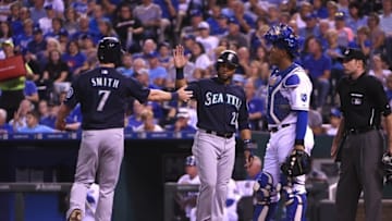 Sep 24, 2015; Kansas City, MO, USA; SSeattle Mariners second baseman Robinson Cano (22) and left fielder Seth Smith (7) celebrate after scoring against the Kansas City Royals in the fourth inning at Kauffman Stadium. Mandatory Credit: John Rieger-USA TODAY Sports
