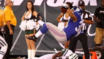 Aug. 18, 2011; East Rutherford, NJ, USA; New York Giants defensive back Will Hill (38) scores a touchdown over New York Jets defensive back Julian Posey (21) during the fourth quarter at MetLife Stadium. Giants won 26-3. Mandatory Credit: Debby Wong-USA TODAY Sports
