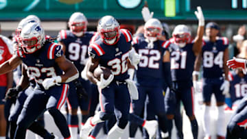 EAST RUTHERFORD, NEW JERSEY - SEPTEMBER 19: (NEW YORK DAILIES OUT) Devin McCourty #32 of the New England Patriots runs the ball after his interception against the New York Jets at MetLife Stadium on September 19, 2021 in East Rutherford, New Jersey. The Patriots defeated the Jets 25-6. (Photo by Jim McIsaac/Getty Images)
