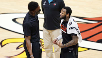 Bam Adebayo #13 of the Miami Heat laughs with John Wall #1 of the Houston Rockets(Photo by Michael Reaves/Getty Images)