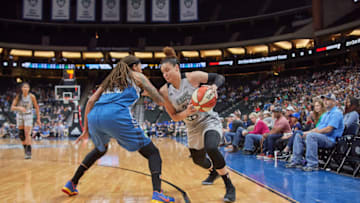 San Antonio Stars guard Kayla McBride looks to drive against Minnesota Lynx guard Seimone Augustus. Photo by Abe Booker, III