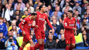 LONDON, ENGLAND - SEPTEMBER 22: Trent Alexander-Arnold of Liverpool celebrates with teammates Virgil van Dijk and Roberto Firmino after scoring his team's first goal during the Premier League match between Chelsea FC and Liverpool FC at Stamford Bridge on September 22, 2019 in London, United Kingdom. (Photo by Laurence Griffiths/Getty Images)