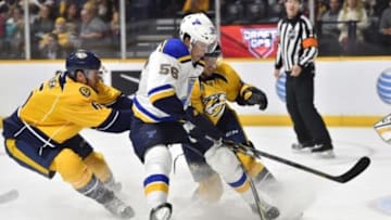 Feb 2, 2016; Nashville, TN, USA; St. Louis Blues left winger Magnus Paajarvi (56) has the puck knocked away by Nashville Predators defenseman Roman Josi (59) and defenseman Shea Weber (6) during the second period at Bridgestone Arena. Mandatory Credit: Christopher Hanewinckel-USA TODAY Sports