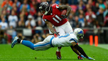LONDON, ENGLAND - OCTOBER 26: Julio Jones #11 of the Atlanta Falcons evades the tackle from Glover Quin #27 of the Detroit Lions during the NFL match between Detroit Lions and Atlanta Falcons at Wembley Stadium on October 26, 2014 in London, England. (Photo by Mike Hewitt/Getty Images)