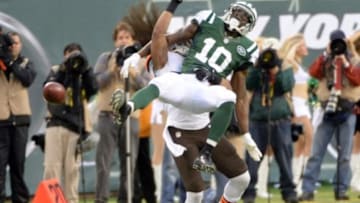 Dec 22, 2013; East Rutherford, NJ, USA; Cleveland Browns cornerback Leon McFadden (29) breaks up a pass intended for New York Jets wide receiver Santonio Holmes (10) during the game at MetLife Stadium. Mandatory Credit: Robert Deutsch-USA TODAY Sports