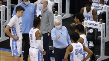 GREENSBORO, NORTH CAROLINA - MARCH 10: Head coach Roy Williams of the North Carolina Tar Heels speaks with his team under a timeout during the second half of their second round game against the Notre Dame Fighting Irish in the ACC Men's Basketball Tournament at Greensboro Coliseum on March 10, 2021 in Greensboro, North Carolina. (Photo by Jared C. Tilton/Getty Images)