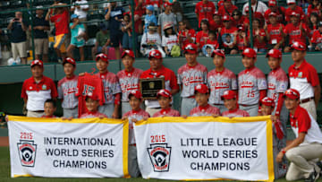 SOUTH WILLAMSPORT, PA - AUGUST 30: Members of team Japan pose with the championship banner after their 18-11 win over the Mid-Atlantic team from Red Land Little League of Lewisberry, Pennsylvania during the Little League World Series Championship game at Lamade Stadium on August 30, 2015 in South Willamsport, Pennsylvania. (Photo by Rob Carr/Getty Images)
