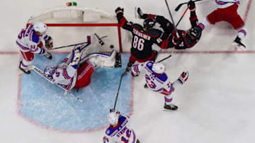 Jan 21, 2022; Raleigh, North Carolina, USA; Carolina Hurricanes center Sebastian Aho (20) scores a goal past New York Rangers goaltender Alexandar Georgiev (40) during the second period at PNC Arena. Mandatory Credit: James Guillory-USA TODAY Sports