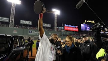 Oct 30, 2013; Boston, MA, USA; Boston Red Sox designated hitter David Ortiz (left) hoists the series MVP trophy while being interviewed by FOX reporter Erin Andrews after game six of the MLB baseball World Series against the St. Louis Cardinals at Fenway Park. The Red Sox won 6-1 to win the series four games to two. Mandatory Credit: Robert Deutsch-USA TODAY Sports