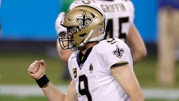 CHARLOTTE, NORTH CAROLINA - JANUARY 03: Quarterback Drew Brees #9 of the New Orleans Saints reacts after throwing a touchdown pass during the second half of their game against the Carolina Panthers at Bank of America Stadium on January 03, 2021 in Charlotte, North Carolina. (Photo by Jared C. Tilton/Getty Images)
