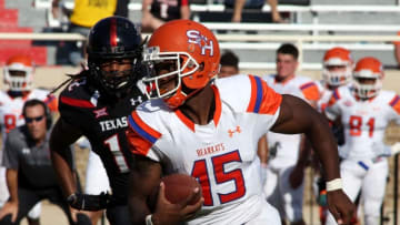 Sep 5, 2015; Lubbock, TX, USA; Sam Houston State quarterback Jared Johnson (15) rushes against the Texas Tech Red Raiders defense in the second half at Jones AT&T Stadium. Texas Tech defeated Sam Houston State 59-45. Mandatory Credit: Michael C. Johnson-USA TODAY Sports