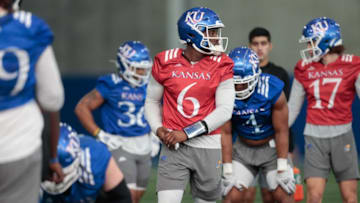 Kansas junior quarterback Jalon Daniels (6) works on drills during practice Tuesday morning in Lawrence.
