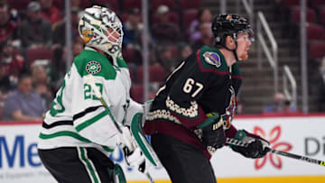 Feb 20, 2022; Glendale, Arizona, USA; Arizona Coyotes left wing Lawson Crouse (67) screens Dallas Stars goaltender Jake Oettinger (29) during the first period at Gila River Arena. Mandatory Credit: Joe Camporeale-USA TODAY Sports