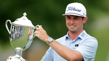 GREENSBORO, NORTH CAROLINA - AUGUST 04: J.T. Poston celebrates with the trophy after winning the Wyndham Championship at Sedgefield Country Club on August 04, 2019 in Greensboro, North Carolina. (Photo by Tyler Lecka/Getty Images)