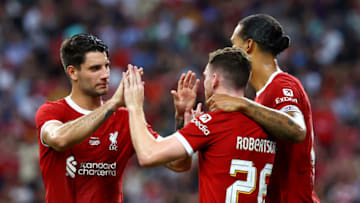 SINGAPORE, SINGAPORE - AUGUST 02: Virgil van Dijk #4 (R) of Liverpool celebrates with Dominik Szoboszlai #8 (L) and Andy Robertson #26 after scoring their second goal off a header against Bayern Munich during the first half of the pre-season friendly at the National Stadium on August 02, 2023 in Singapore. (Photo by Yong Teck Lim/Getty Images)
