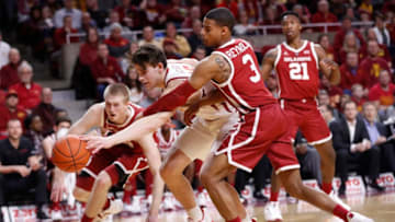 AMES, IA - FEBRUARY 25: Michael Jacobson #12 of the Iowa State Cyclones battles for the ball with Brady Manek #35 of the Oklahoma Sooners, left, and Miles Reynolds #3 of the Oklahoma Sooners in the first half of play at Hilton Coliseum on February 25, 2019 in Ames, Iowa. (Photo by David Purdy/Getty Images)