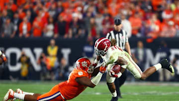 Jan 11, 2016; Glendale, AZ, USA; Alabama Crimson Tide running back Derrick Henry (2) is tackled by Clemson Tigers defensive tackle Carlos Watkins (94) in the 2016 CFP National Championship at University of Phoenix Stadium. Mandatory Credit: Mark J. Rebilas-USA TODAY Sports