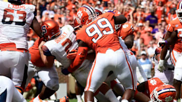 CLEMSON, SC - SEPTEMBER 29: Quarterback Eric Dungey #2 of the Syracuse Orange slips past defensive end Clelin Ferrell #99 of the Clemson Tigers for a touchdown during the fourth quarter of the football game at Clemson Memorial Stadium on September 29, 2018 in Clemson, South Carolina. (Photo by Mike Comer/Getty Images)