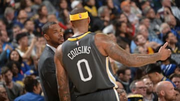 OAKLAND, CA - FEBRUARY 12: Assistant Coach Jarron Collins and DeMarcus Cousins #0 of the Golden State Warriors talk during the game against the Utah Jazz on February 12, 2019 at ORACLE Arena in Oakland, California. NOTE TO USER: User expressly acknowledges and agrees that, by downloading and/or using this photograph, user is consenting to the terms and conditions of Getty Images License Agreement. Mandatory Copyright Notice: Copyright 2019 NBAE (Photo by Noah Graham/NBAE via Getty Images)