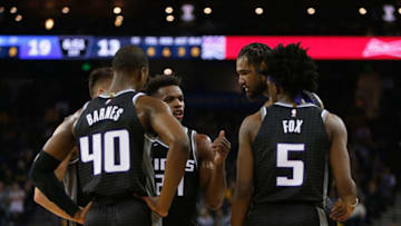 OAKLAND, CA - FEBRUARY 21: Sacramento Kings players (L-R) Harrison Barnes #40, Bogdan Bogdanovic (obscured) #8, Buddy Hield #24, Willie Cauley-Stein #00 and De'Aaron Fox #5 talk during a timeout from the game against the Golden State Warriors at ORACLE Arena on February 21, 2019 in Oakland, California. NOTE TO USER: User expressly acknowledges and agrees that, by downloading and or using this photograph, User is consenting to the terms and conditions of the Getty Images License Agreement. (Photo by Lachlan Cunningham/Getty Images)