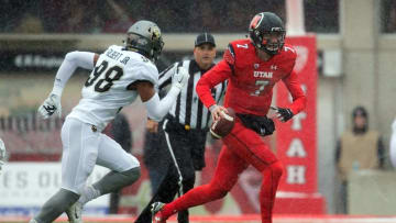 Nov 28, 2015; Salt Lake City, UT, USA; Utah Utes quarterback Travis Wilson (7) runs with the ball as Colorado Buffaloes defensive end Jimmie Gilbert Jr. (98) pursues the play during the first half at Rice-Eccles Stadium. Utah won 20-14. Mandatory Credit: Russ Isabella-USA TODAY Sports