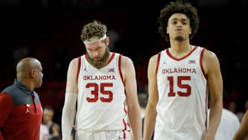 Oklahoma's Tanner Groves (35) and Ethan Chargois (15) walk off the court after a men's college basketball game between the University of Oklahoma Sooners (OU) and St. Bonaventure at Lloyd Noble Center in Norman, Okla., Sunday, March 20, 2022. St. Bonaventure won 70-68.Ou Nit