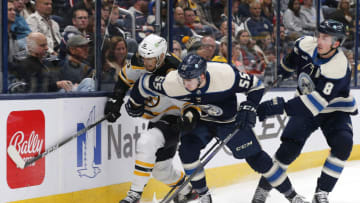 Oct 28, 2022; Columbus, Ohio, USA; Columbus Blue Jackets defenseman David Jiricek (55) and Boston Bruins left wing A.J. Greer (10) battle for the puck during the third period at Nationwide Arena. Mandatory Credit: Russell LaBounty-USA TODAY Sports