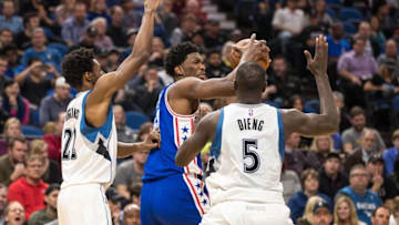 Nov 17, 2016; Minneapolis, MN, USA; Philadelphia 76ers center Joel Embiid (21) controls the ball between Minnesota Timberwolves forward Andrew Wiggins (22) and center Gorgui Dieng (5) during the second quarter at Target Center. Mandatory Credit: Brace Hemmelgarn-USA TODAY Sports