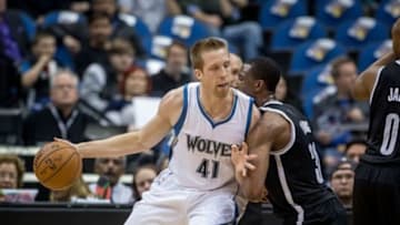 Mar 16, 2015; Minneapolis, MN, USA; Minnesota Timberwolves center Justin Hamilton (41) dribbles as Brooklyn Nets forward Thaddeus Young (30) defends him in the first quarter at Target Center. Mandatory Credit: Bruce Kluckhohn-USA TODAY Sports