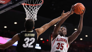 TUCSON, ARIZONA - JANUARY 13: Center Christian Koloko #35 of the Arizona Wildcats snags a rebound in front of guard Nique Clifford #32 of the Colorado Buffaloes during the NCAAB game at McKale Center on January 03, 2022 in Tucson, Arizona. The Arizona Wildcats won 76-55 against the Colorado Buffaloes. (Photo by Rebecca Noble/Getty Images)