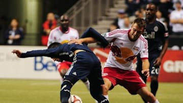 Mar 8, 2014; Vancouver, British Columbia, Canada; Vancouver Whitecaps midfielder Russell Telbert (31) is marked by New York Red Bulls midfielder Eric Alexander (12) during the second half at BC Place. The Vancouver Whitecaps won 4-1. Mandatory Credit: Anne-Marie Sorvin-USA TODAY Sports