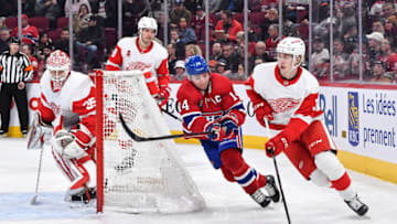 MONTREAL, CANADA - APRIL 04: Simon Edvinsson #3 of the Detroit Red Wings skates the puck against Nick Suzuki #14 of the Montreal Canadiens during the second period at Centre Bell on April 4, 2023 in Montreal, Quebec, Canada. (Photo by Minas Panagiotakis/Getty Images)