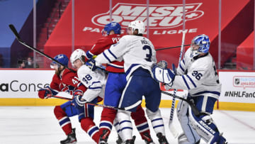 MONTREAL, QC - MAY 24: Goaltender Jack Campbell #36 of the Toronto Maple Leafs defends his net with the help of his teammates Justin Holl #3 and Rasmus Sandin #38 against Corey Perry #94 and Paul Byron #41 of the Montreal Canadiens during the second period in Game Three of the First Round of the 2021 Stanley Cup Playoffs at the Bell Centre on May 24, 2021 in Montreal, Canada. (Photo by Minas Panagiotakis/Getty Images)