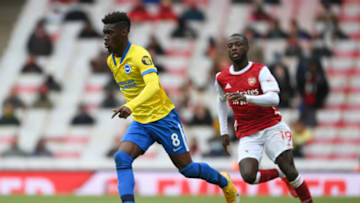 LONDON, ENGLAND - MAY 23: Yves Bissouma of Brighton & Hove Albion is put under pressure by Nicolas Pepe of Arsenal during the Premier League match between Arsenal and Brighton & Hove Albion at Emirates Stadium on May 23, 2021 in London, England. A limited number of fans will be allowed into Premier League stadiums as Coronavirus restrictions begin to ease in the UK. (Photo by Mike Hewitt/Getty Images)