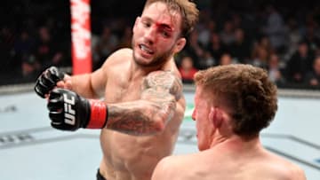 MELBOURNE, AUSTRALIA - OCTOBER 06: (L-R) Brad Riddell of New Zealand punches Jamie Mullarkey of Australia in their lightweight fight during the UFC 243 event at Marvel Stadium on October 06, 2019 in Melbourne, Australia. (Photo by Jeff Bottari/Zuffa LLC/Zuffa LLC via Getty Images)