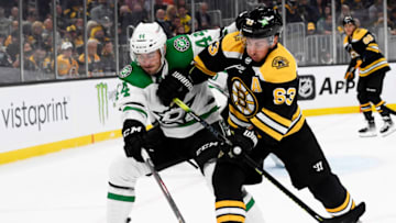 Oct 16, 2021; Boston, Massachusetts, USA; Dallas Stars defenseman Joel Hanley (44) and Boston Bruins center Brad Marchand (63) battle for position during the first period at TD Garden. Mandatory Credit: Bob DeChiara-USA TODAY Sports